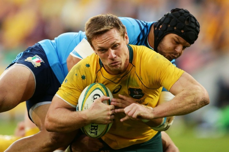DANE HAYLETT-PETTY of the Wallabies is tackled during the International Test match between the Australian Wallabies and Italy at Suncorp Stadium in Brisbane, Australia.