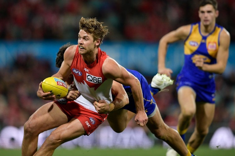 DANE RAMPE of the Swans is tackled during the AFL match between the Sydney Swans and the West Coast Eagles at SCG in Sydney, Australia.