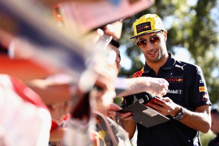 DANIEL RICCIARDO of Australia and Red Bull Racing arrives at the circuit and signs autographs for fans before practice for the Australian Formula One Grand Prix at Albert Park in Melbourne, Australia.
