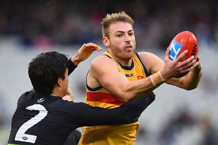 DANIEL TALIA of the Crows is tackled by Jack Silvagni of the Blues during the AFL match between the Carlton Blues and the Adelaide Crows at MCG in Melbourne, Australia. DANIEL TALIA of the Crows is tackled by Jack Silvagni of the Blues during the AFL match between the Carlton Blues and the Adelaide Crows at MCG in Melbourne, Australia.