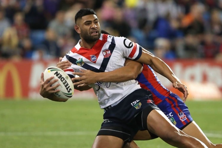 DANIEL TUPOU of the Roosters is tackled during the NRL match between the Newcastle Knights and the Sydney Roosters at McDonald Jones Stadium in Newcastle, Australia.