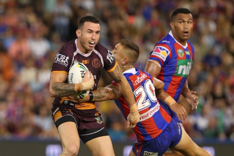 DARIUS BOYD of the Broncos is tackled during the NRL match between the Newcastle Knights and the Brisbane Broncos at McDonald Jones Stadium in Newcastle, Australia.
