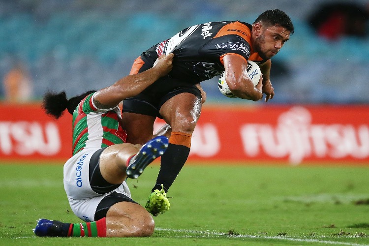 DAVID NFOALUMA of the Tigers is tackled by Siosifa Talakai of the Rabbitohs during the NRL match between the South Sydney Rabbitohs and the Wests Tigers at ANZ Stadium in Sydney, Australia.