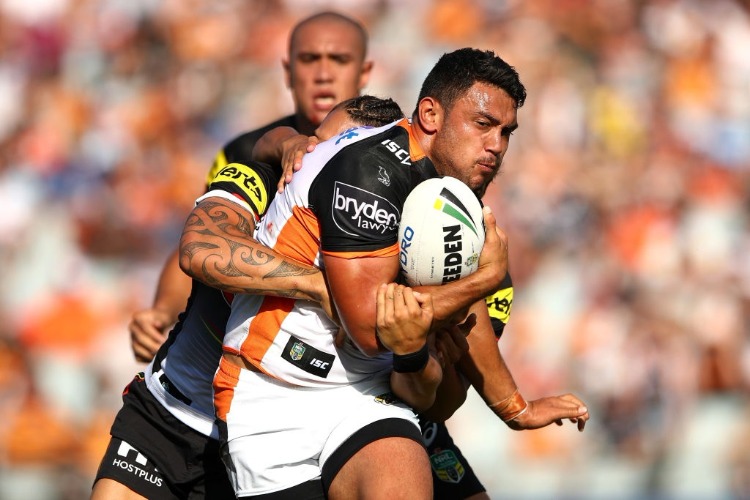 DAVID NOFOALUMA of the Tigers is tackled during the NRL match between the Wests Tigers and the Penrith Panthers at Campbelltown Sports Stadium in Sydney, Australia.