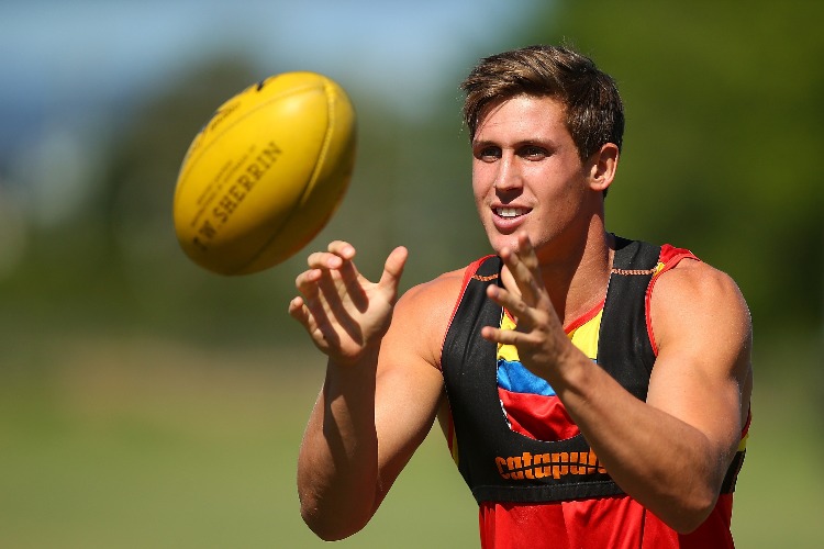 DAVID SWALLOW catches a ball during a Gold Coast Suns AFL training session at Metricon Stadium in Gold Coast, Australia.