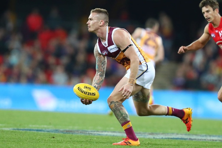 DAYNE BEAMS of the Lions handballs during the AFL match between the Gold Coast Suns and Brisbane Lions at Metricon Stadium in Gold Coast, Australia.