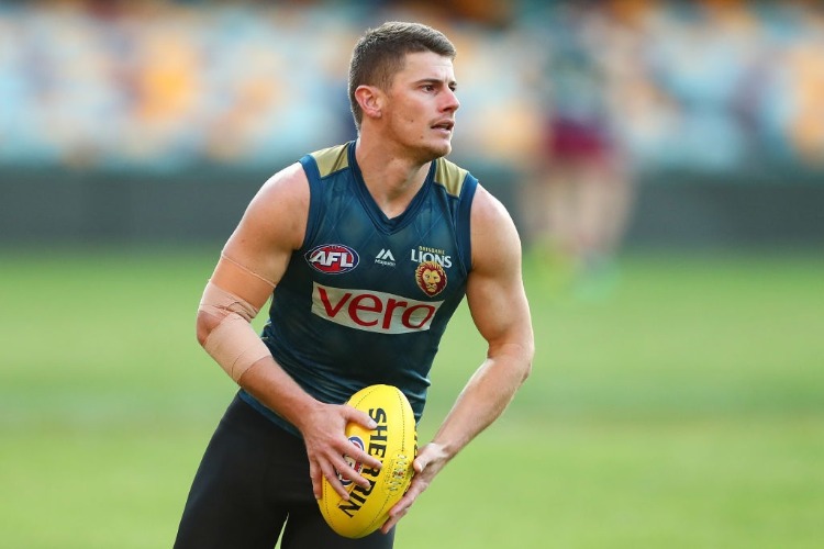 DAYNE ZORKO runs the ball during the Brisbane Lions AFL training session at The Gabba in Brisbane, Australia.