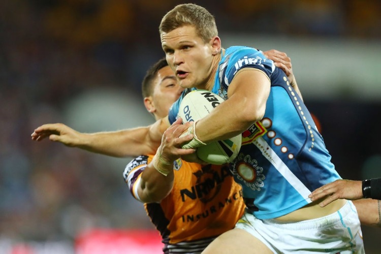 DALE COPLEY of the Titans is tackled during the NRL match between the Gold Coast Titans and the Brisbane Broncos at Cbus Super Stadium in Gold Coast, Australia.