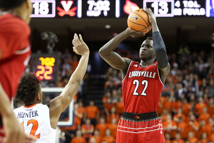 DENG ADEL #22 of the Louisville Cardinals shoots during a game against the Virginia Cavaliers at John Paul Jones Arena in Charlottesville, Virginia. DENG ADEL #22 of the Louisville Cardinals shoots during a game against the Virginia Cavaliers at John Paul Jones Arena in Charlottesville, Virginia.