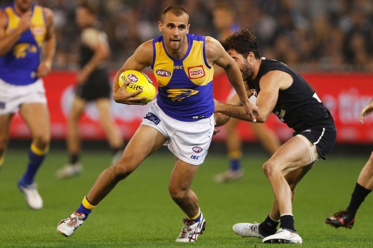 DOM SHEED of the Eagles runs with the ball during the AFL match between the Carlton Blues and the West Coast Eagles at MCG in Melbourne, Australia.