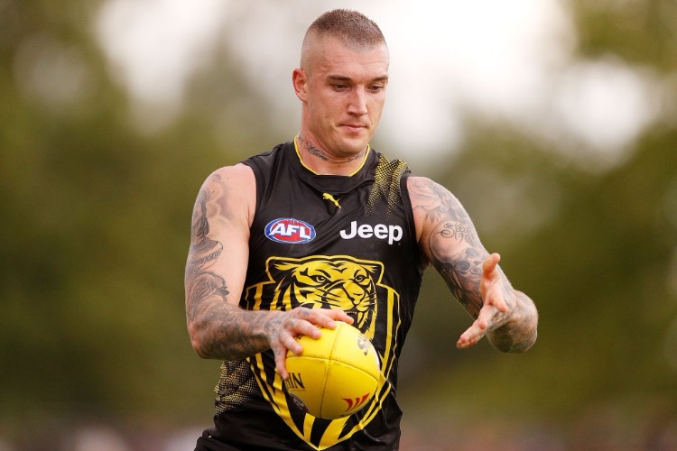 DUSTIN MARTIN of the Tigers runs with the ball during the JLT Community Series AFL match between the Essendon Bombers and the Richmond Tigers at Norm Minns Oval in Wangaratta, Australia.