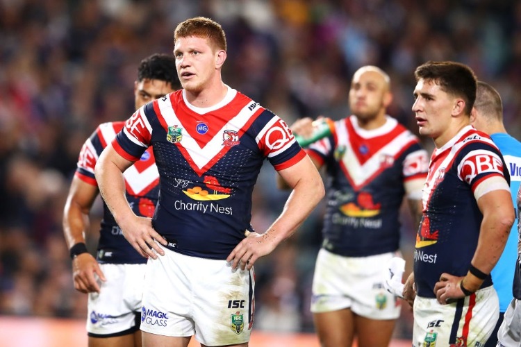 Dylan Napa of the Roosters looks dejected as he watches on during the NRL match between the Sydney Roosters and the Brisbane Broncos at Allianz Stadium.