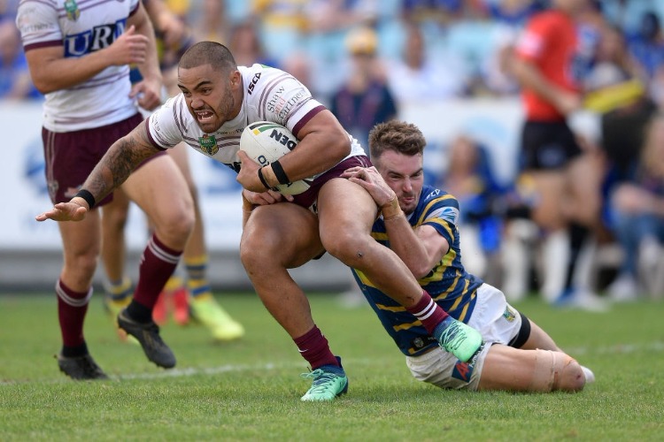 DYLAN WALKER of Manly is tackled during the NRL match between the Parramatta Eels and the Manly Sea Eagles at ANZ Stadium in Sydney, Australia.