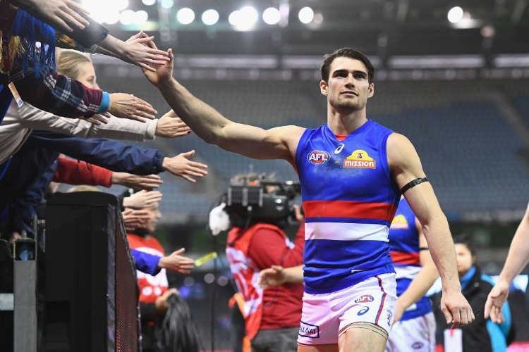 EASTON WOOD of the Bulldogs high fives fans after winning the AFL match between the Carlton Blues and the Western Bulldogs at Etihad Stadium in Melbourne, Australia.