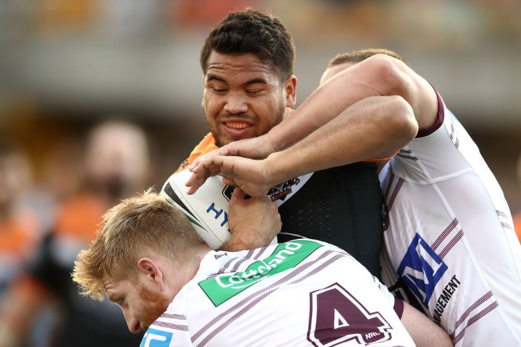 ESAN MARSTERS of the Tigers is tackled during the NRL match between the Wests Tigers and the Manly Sea Eagles at Leichhardt Oval in Sydney, Australia.