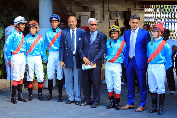 Trainer Soun Gujadhur (fourth from right) and son Mukund (second from right) with their five jockeys.