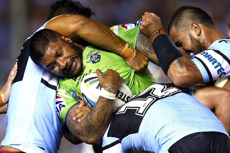 FRANK PAUL NUUAUSALA of the Raiders is tackled by Tinirau Arona, Andrew Fifita and Wade Graham of the Sharks during the NRL match between the Cronulla Sharks and the Canberra Raiders at Remondis Stadium in Sydney, Australia.