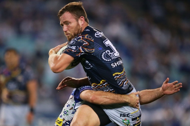 GAVIN COOPER of the Cowboys is tackled during the NRL match between the Canterbury Bulldogs and the North Queensland Cowboys at ANZ Stadium in Sydney, Australia.