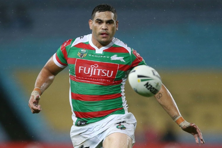 GREG INGLIS of the Rabbitohs watches the ball before scoring a try during the NRL match between the South Sydney Rabbitohs and the Wests Tigers at ANZ Stadium in Australia.
