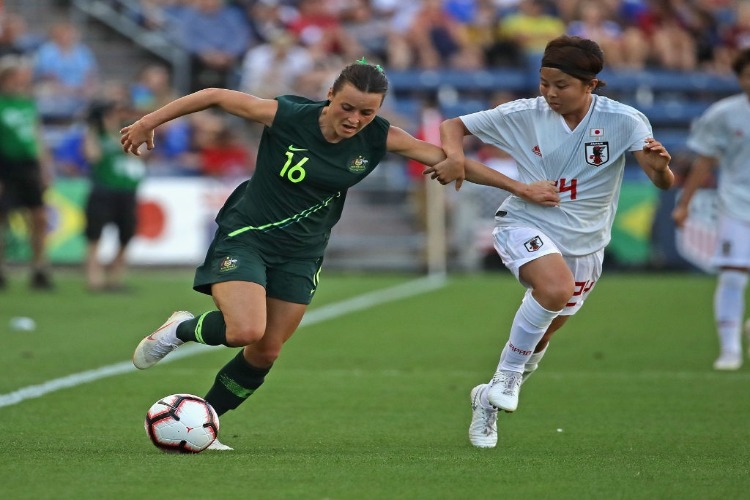 HAYLEY RASO Australia holds off Narumi Miura of Japan during the Tournament Of Nations at Toyota Park in Bridgeview, Illinois.