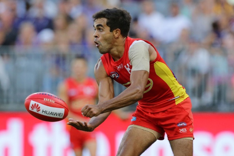 JACK MARTIN of the Suns handpasses the ball during the AFL match between the Gold Coast Suns and the Fremantle Dockers at Optus Stadium in Perth, Australia.
