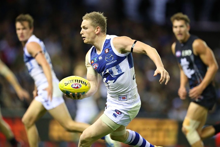 JACK ZIEBELL of the Kangaroos runs with the ball during an AFL match at Etihad Stadium in Melbourne, Australia.