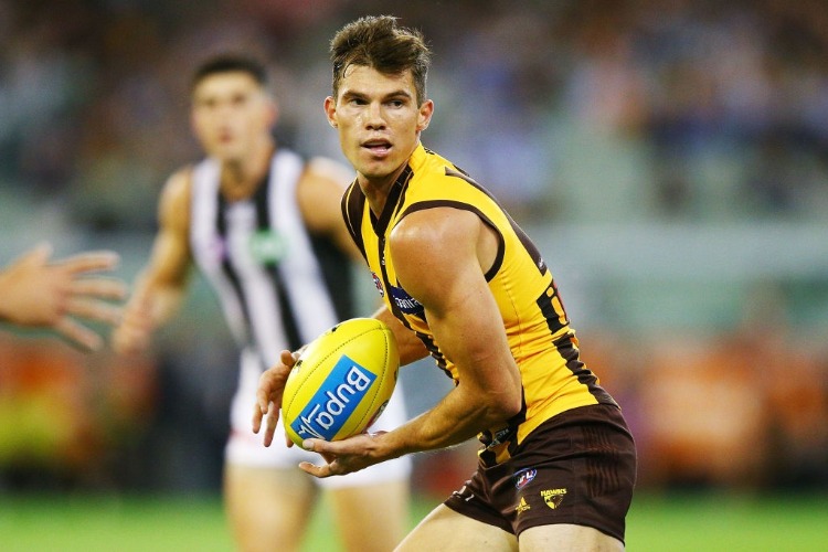 JAEGER O'MEARA of the Hawks runs the ball during the AFL match between the Hawthorn Hawks and the Collingwood Magpies at MCG in Melbourne, Australia.