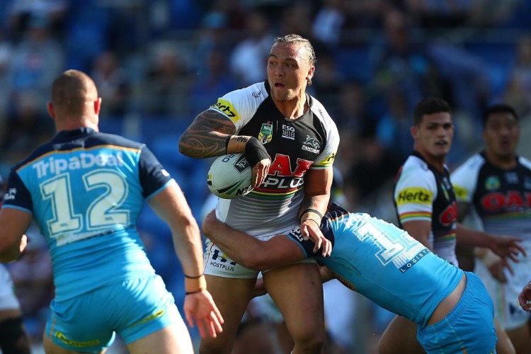 JAMES FISHER-HARRIS of the Panthers is tackled during the NRL match between the Gold Coast Titans and the Penrith Panthers at CSS in Gold Coast, Australia.