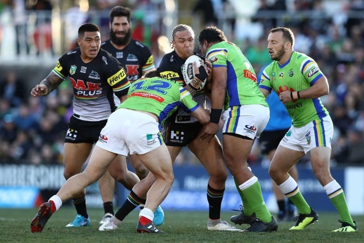 JAMES FISHER-HARRIS of the Panthers is tackled by Elliott Whitehead of the Raiders during the NRL match between the Penrith Panthers and the Canberra Raiders at PS in Penrith, Australia.