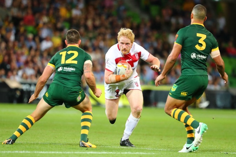 JAMES GRAHAM of England is tackled during the 2017 Rugby League World Cup match between the Australian Kangaroos and England at AAMI Park in Melbourne, Australia.