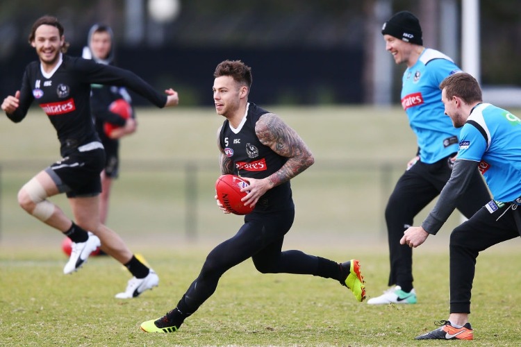 JAMIE ELLIOTT of the Magpies runs with the ball during a Collingwood Magpies AFL training session at Holden Centre in Melbourne, Australia.