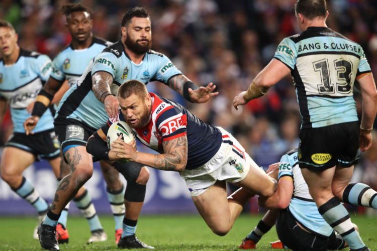 JARED WAEREA-HARGREAVES of the Roosters is tackled during the NRL Qualifying Final match between the Sydney Roosters and the Cronulla Sharks at Allianz Stadium in Sydney, Australia.