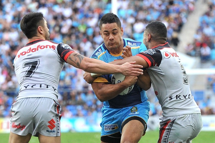 JARRYD HAYNE of the Titans takes on the defence during the NRL match between the Gold Coast Titans and the New Zealand Warriors at Cbus Super Stadium in Gold Coast, Australia.