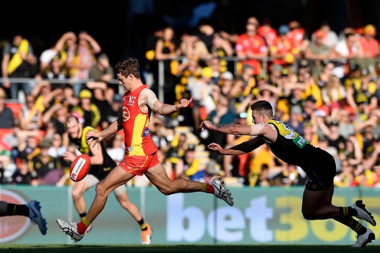 JARRYD LYONS of the Suns breaks away from the defence during the AFL match between the Gold Coast Suns and the Richmond Tigers at MS in Gold Coast, Australia.