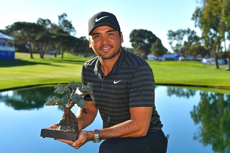 JASON DAY of Australia poses with the trophy of the Farmers Insurance Open at Torrey Pines South in San Diego, California.