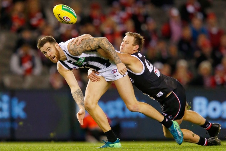 David Armitage of the Saints tackles JEREMY HOWE of the Magpies during the AFL match between the St Kilda Saints and the Collingwood Magpies at Etihad Stadium in Melbourne, Australia.