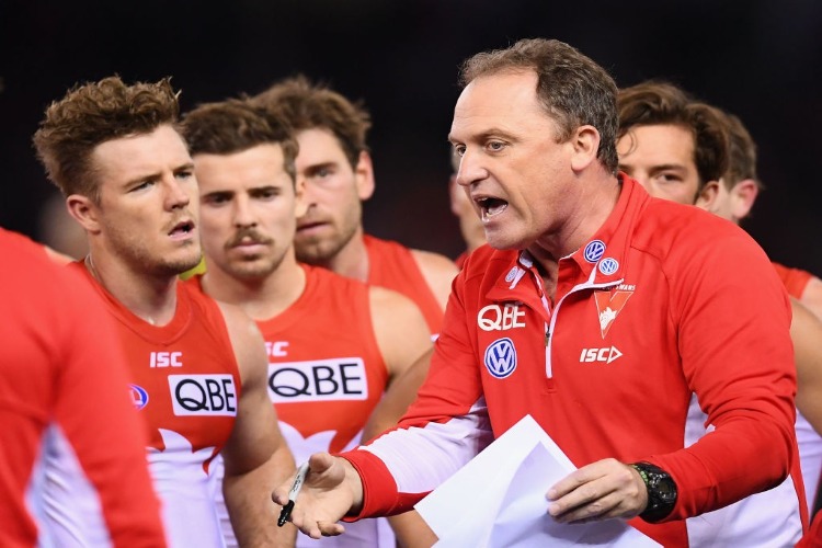 Swans head coach JOHN LONGMIRE talks to his players during the AFL match between the Essendon Bombers and the Sydney Swans at ES in Melbourne, Australia.