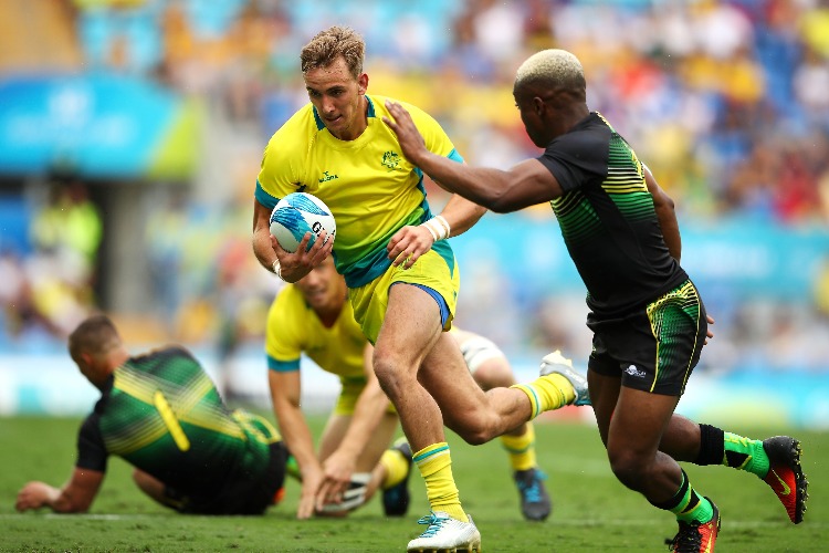 JOHN PORCH of Australia runs the ball during the Rugby Sevens match between Australia and Jamaica of the Gold Coast 2018 Commonwealth Games at Robina Stadium on the Gold Coast, Australia. JOHN PORCH of Australia runs the ball during the Rugby Sevens match between Australia and Jamaica of the Gold Coast 2018 Commonwealth Games at Robina Stadium on the Gold Coast, Australia.