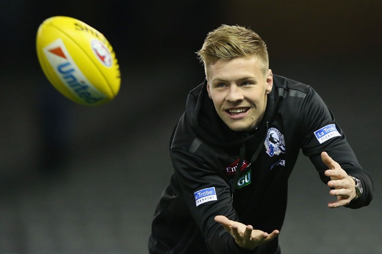 JORDAN DE GOEY of the Magpies marks the ball before warm up during the AFL match between the Collingwood Magpies and the North Melbourne Kangaroos at Etihad Stadium in Melbourne, Australia.