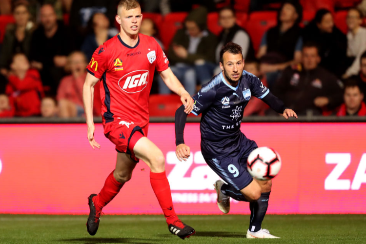 JORDAN ELSEY of Adelaide United competes with Adam Le Fondre of Sydney FC during theA-League match between Adelaide United and Sydney FC at Coopers Stadium in Adelaide, Australia.