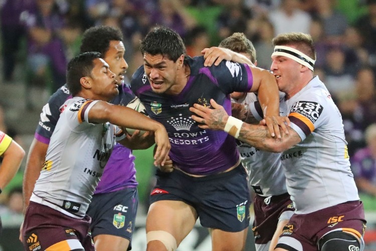 JORDAN MCLEAN of the Melbourne Storm runs with the ball during the NRL match between the Melbourne Storm and the Brisbane Broncos at AAMI Park in Melbourne, Australia.