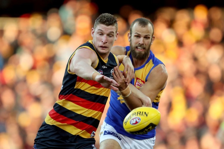 JOSH JENKINS of the Crows is tackled by Will Schofield of the Eagles the West Coast Eagles in Adelaide, Australia.