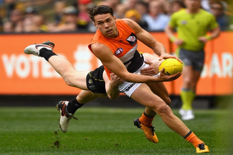JOSH KELLY of the Giants is tackled by Jacob Townsend of the Tigers during the AFL Preliminary Final match between the Richmond Tigers and the Greater Western Sydney Giants at MCG in Melbourne, Australia.