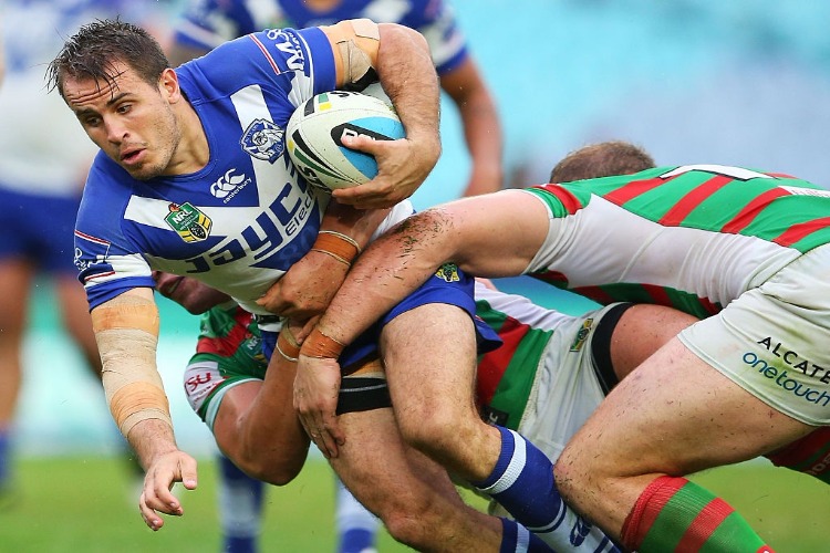 JOSH REYNOLDS of the Bulldogs runs the ball during the NRL match between the Canterbury Bulldogs and the South Sydney Rabbitohs at ANZ Stadium in Sydney, Australia.