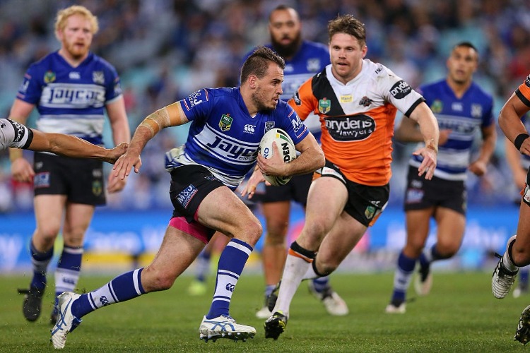 JOSH REYNOLDS of the Bulldogs runs with the ball during the NRL match between the Canterbury Bulldogs and the Wests Tigers at ANZ Stadium in Sydney, Australia.