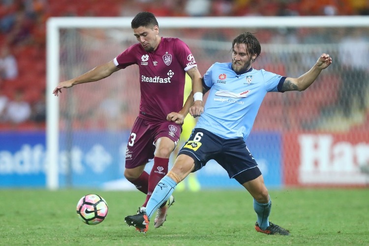Dimitri Petratos of the Roar and JOSHUA BRILLANTE of Sydney FC compete for the ball during the A-League match between the Brisbane Roar and Sydney FC at Suncorp Stadium in Brisbane, Australia.