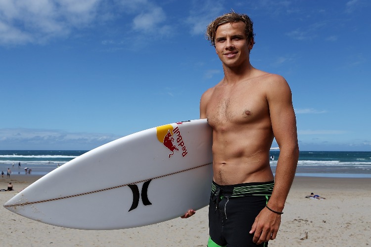 Pro surfer JULIAN WILSON poses for a photograph after giving Slovakian tennis player Daniela Hantuchova a surf lesson at Coolum Beach in Sunshine Coast, Australia.