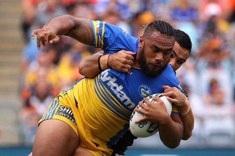 JUNIOR PAULO of the Eels is tackled during the NRL match between the Wests Tigers and the Parramatta Eels at ANZ Stadium in Sydney, Australia.