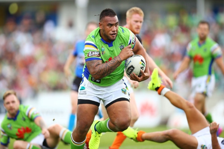 JUNIOR PAULO of the Raiders makes a line break during the NRL match between the Canberra Raiders and the Wests Tigers at GIO Stadium in Canberra, Australia. JUNIOR PAULO of the Raiders makes a line break during the NRL match between the Canberra Raiders and the Wests Tigers at GIO Stadium in Canberra, Australia.