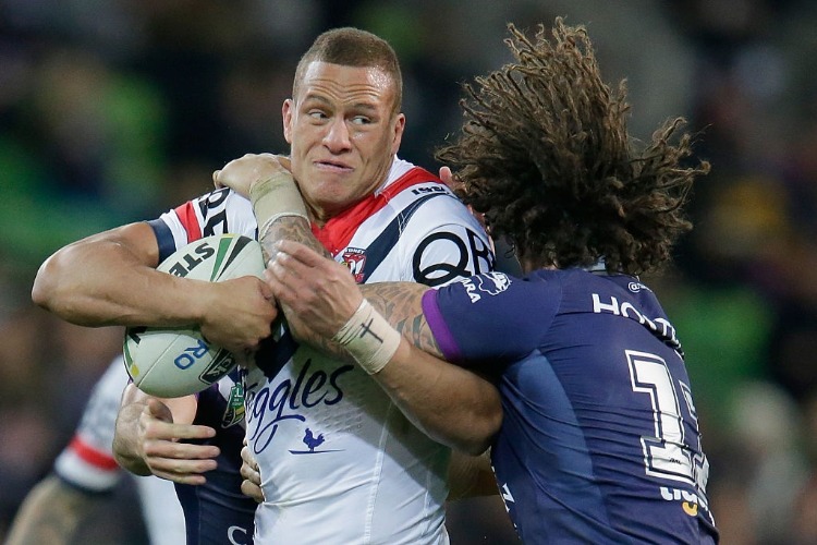 Kevin Proctor of the Storm tackles KENE EVANS of the Roosters during the NRL match between the Melbourne Storm and the Sydney Roosters at AAMI Park in Melbourne, Australia.